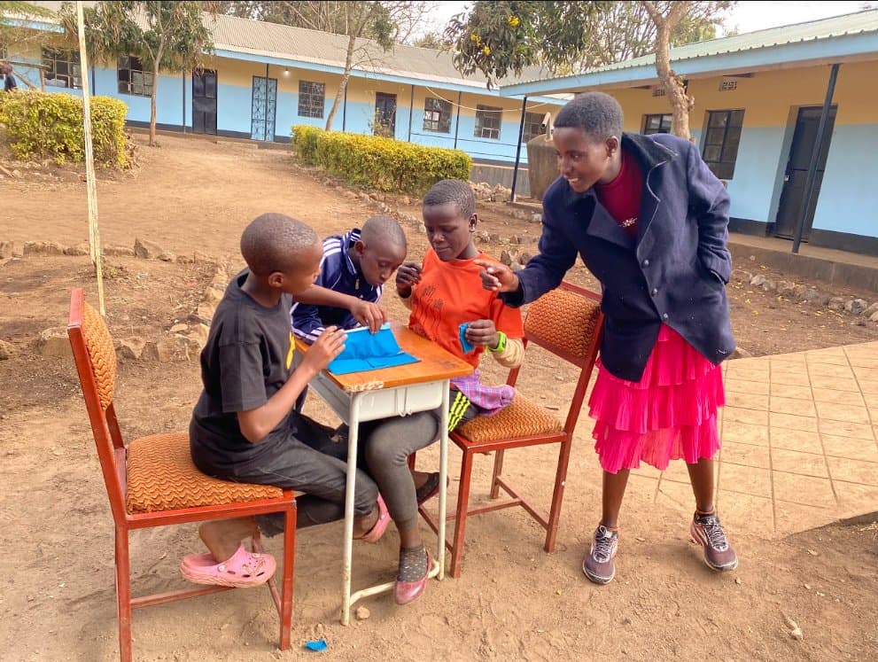 Girls In Motion coach mentoring young girls in Monduli